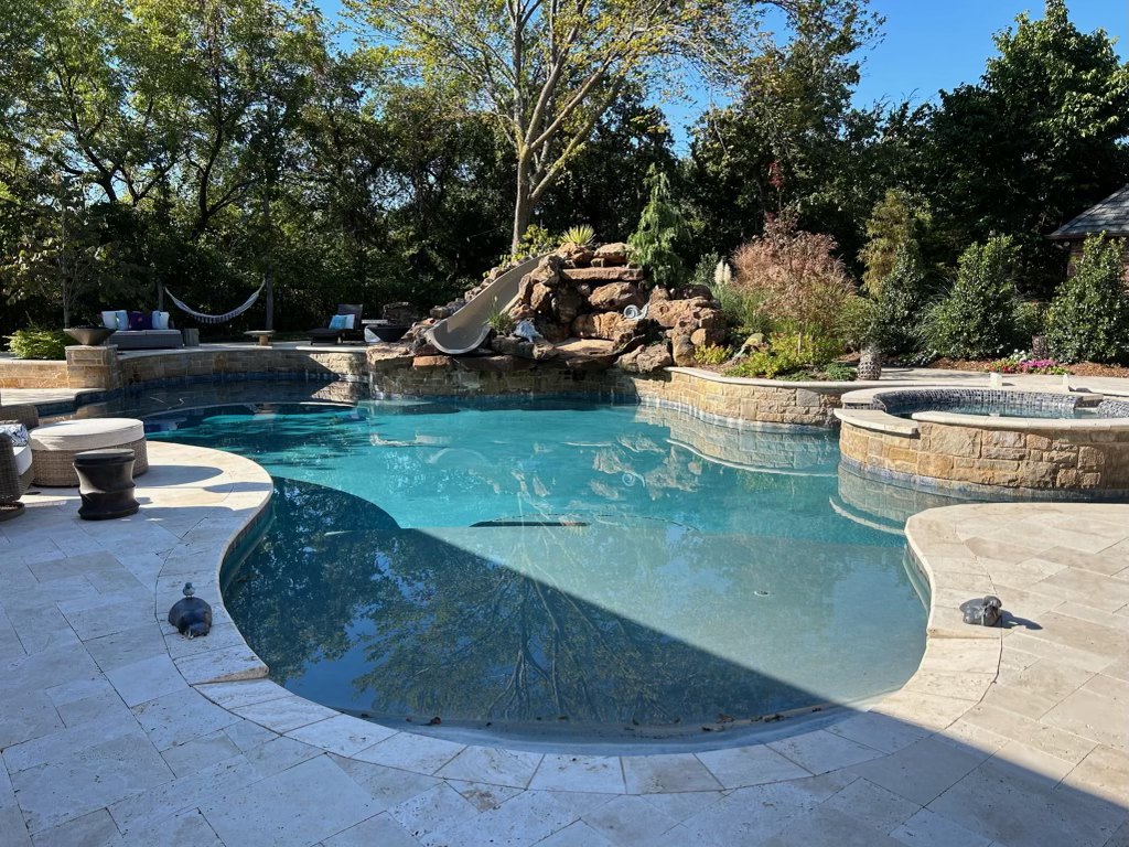 Freeform pool with rock waterfall, slide and raised spa, Oklahoma
