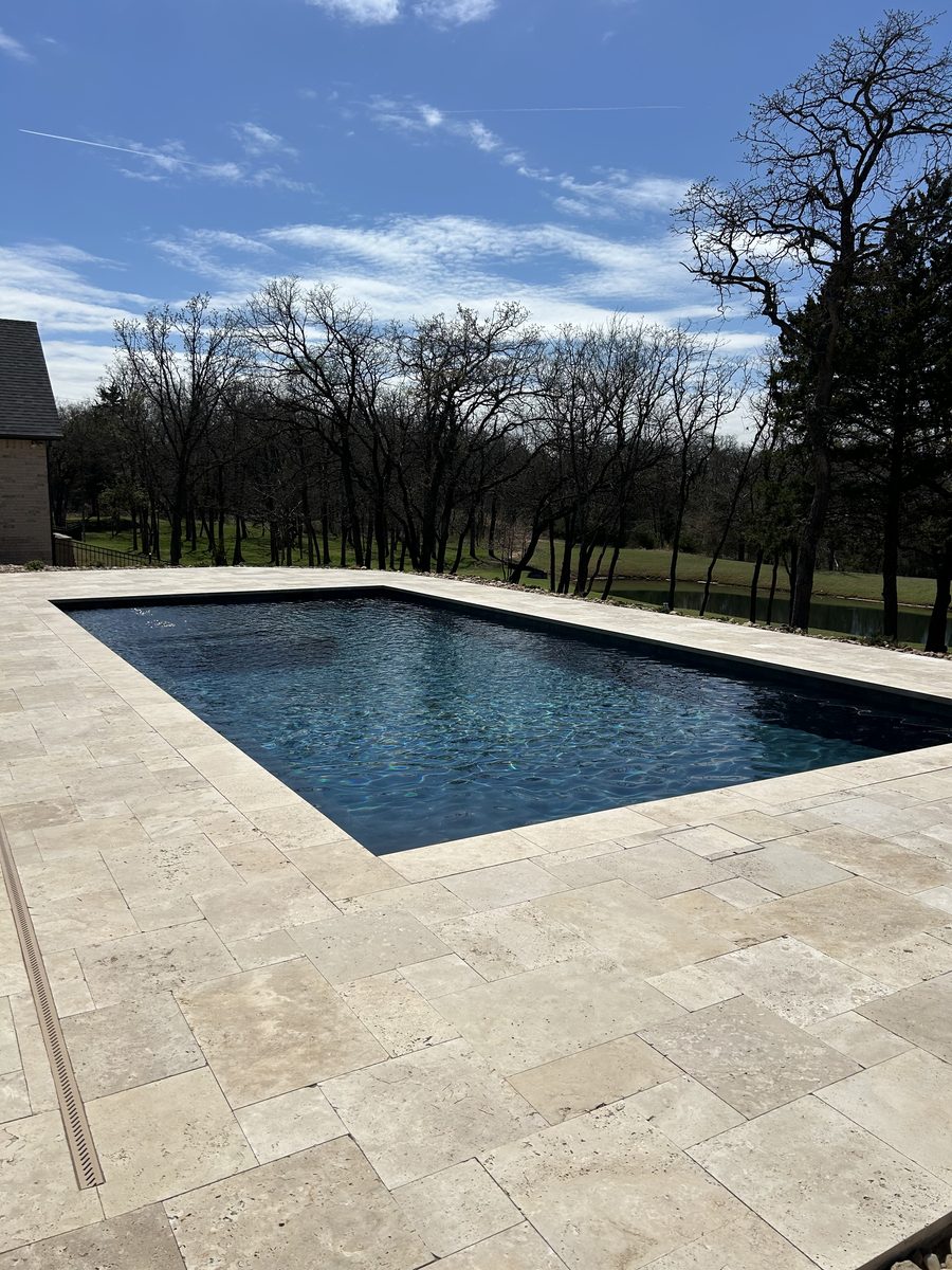 Geometric pool with travertine deck overlooking open country, Oklahoma
