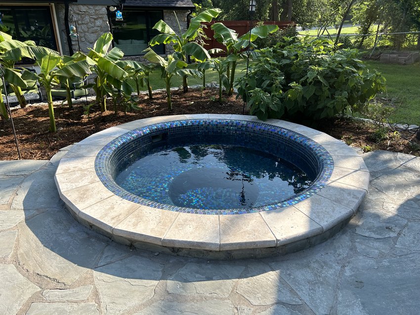 Raised spa with travertine coping and glass tile, Oklahoma